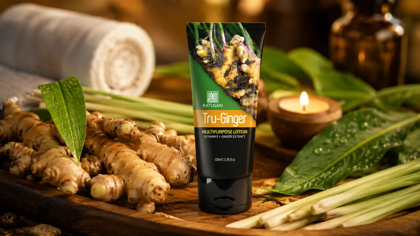Ratusan Tru-Ginger Lotion tube on a warm wooden spa surface with Bentong ginger roots, lemongrass stalks and candlelight