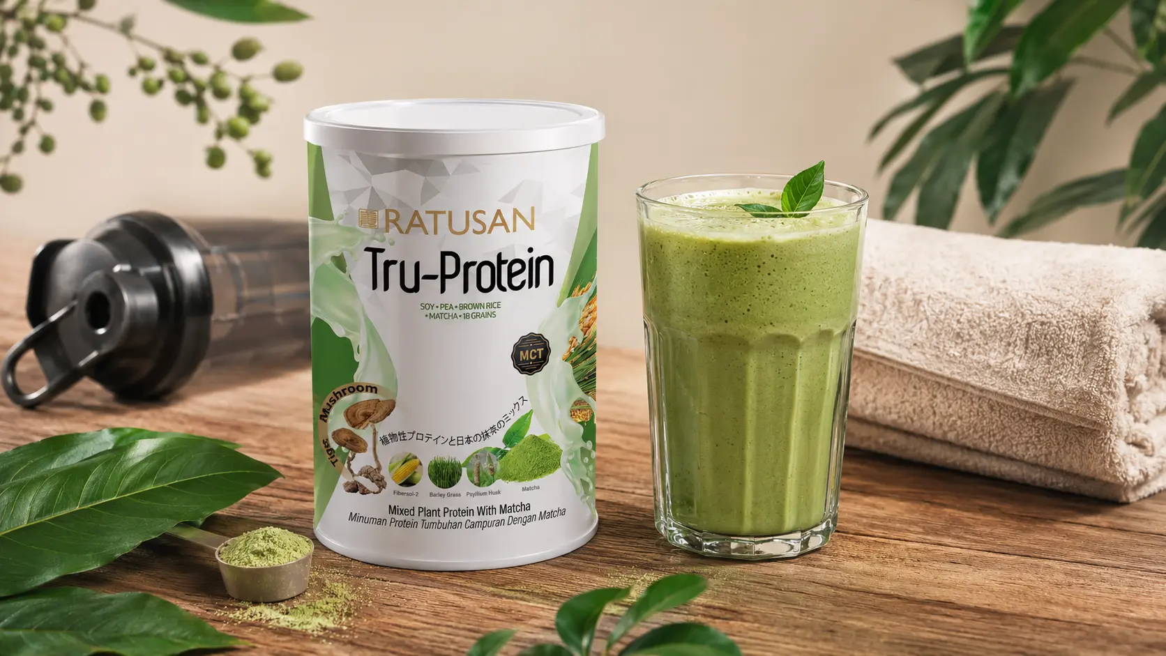 Post-workout flat lay with Ratusan Tru-Protein tin, a green protein smoothie and gym towel on a wooden surface